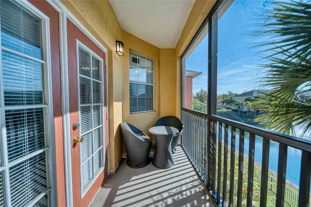 a view of a balcony with chair and wooden floor