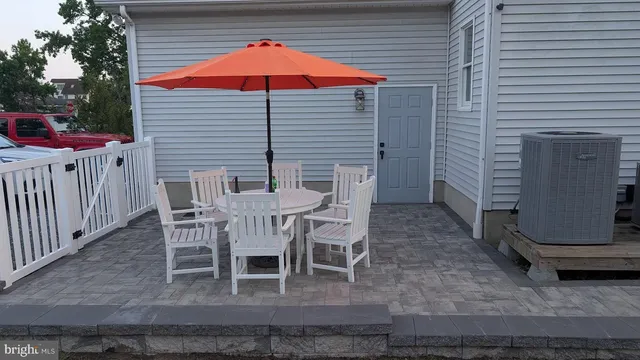 a table and chairs in front of a house