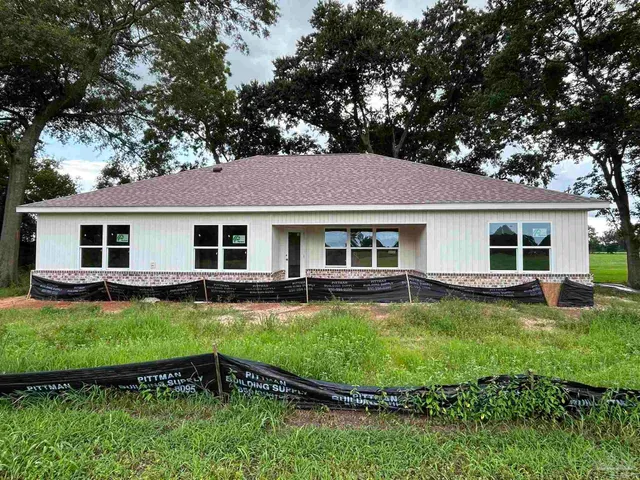 a view of a yard with swimming pool and sitting area
