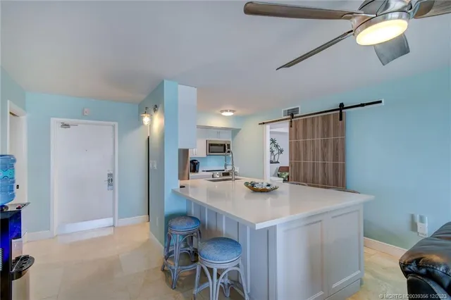 a view of kitchen with refrigerator and window