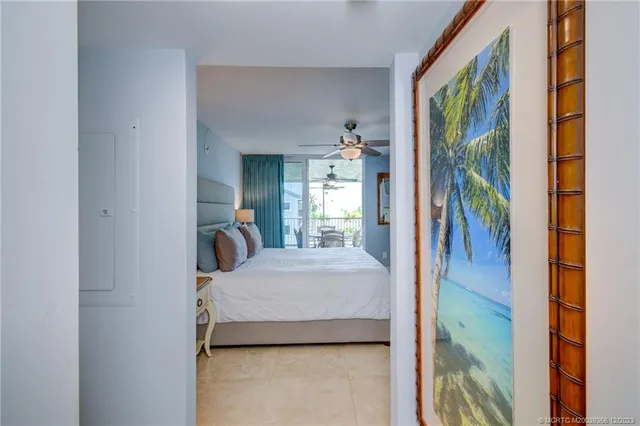 a bedroom with a large bed and a chandelier