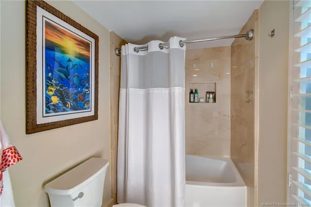 a bedroom with a bed gym equipment and a window