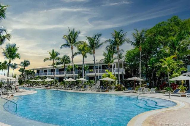 an aerial view of a house with outdoor space and ocean view