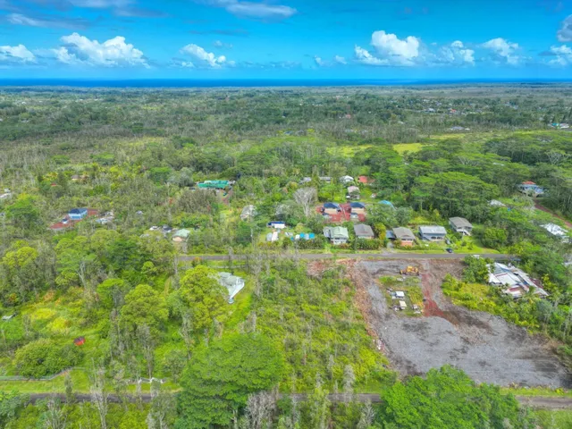 a view of a big yard with lots of green space and windows