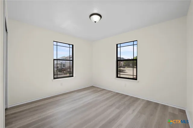 an empty room with windows and closet
