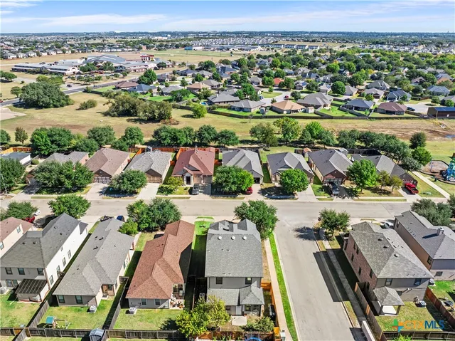an aerial view of residential houses with outdoor space and swimming pool
