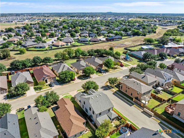an aerial view of residential houses with outdoor space