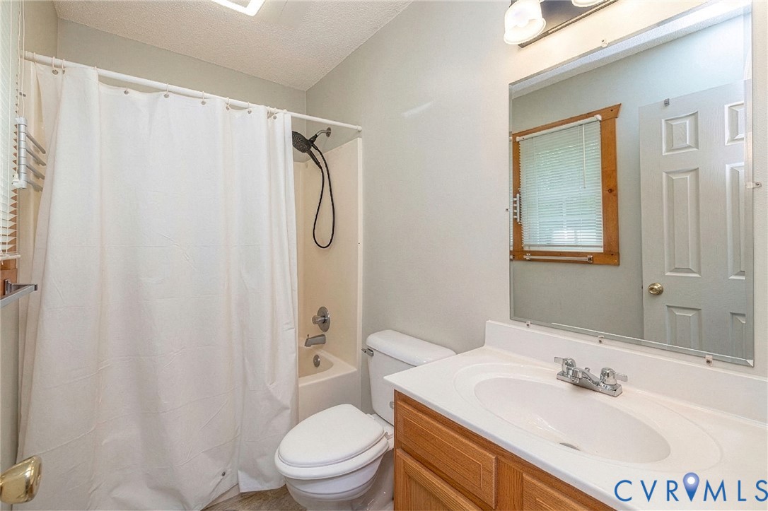 460 Horseshoe Road Jarratt, VA 23867 - Photo 20 of 24 a bathroom with a sink a toilet and shower
