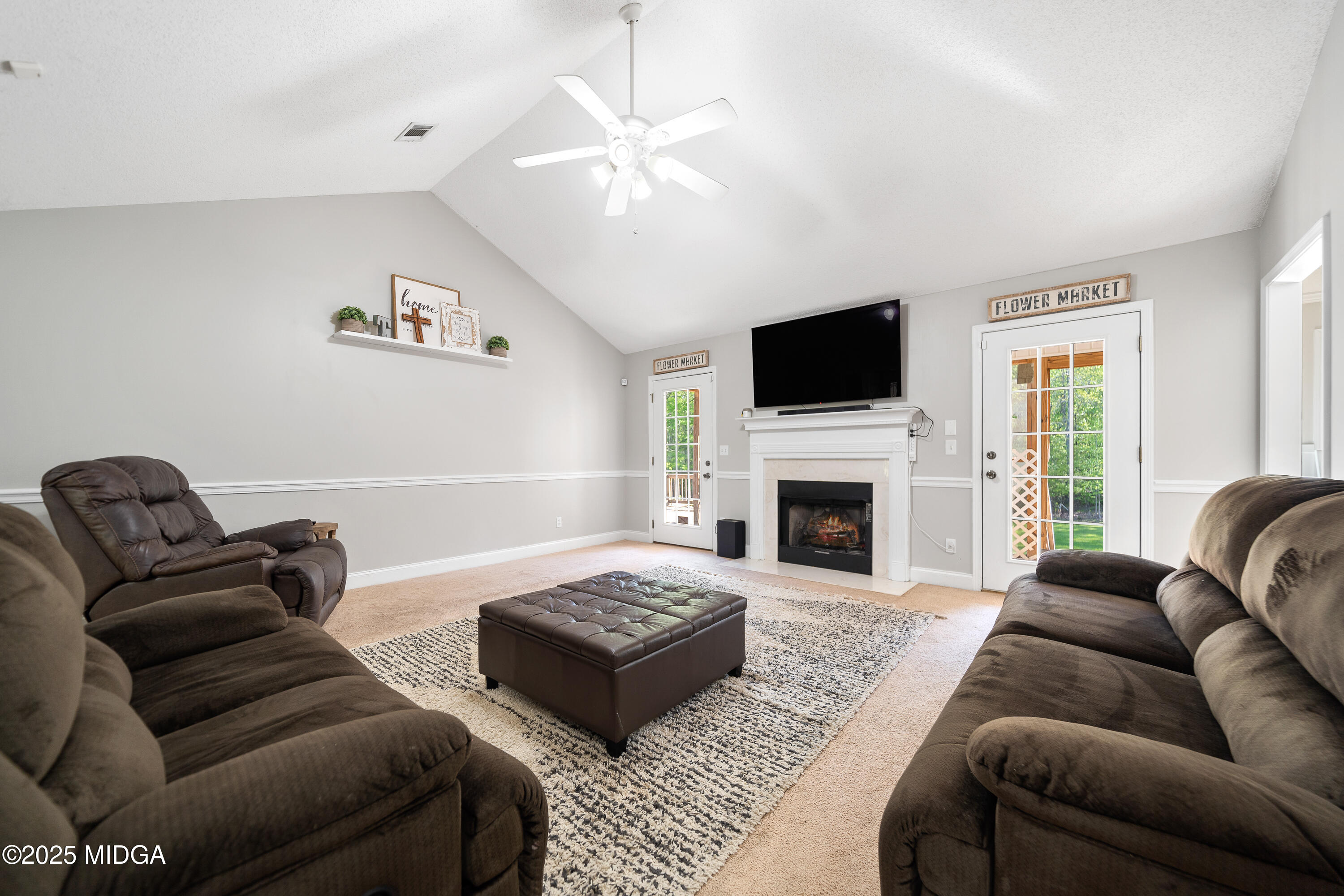 192 Whitaker Road Macon, GA 31211 - Photo 8 of 30 a living room with furniture a fireplace and a flat screen tv