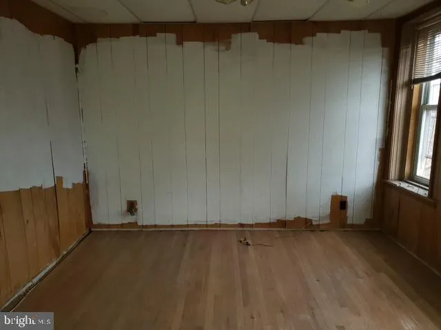 a view of a room with wooden floor and a window
