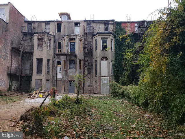 a view of a brick building next to a yard
