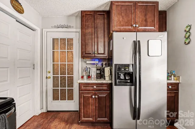 a kitchen with stainless steel appliances granite countertop a refrigerator and a stove top oven