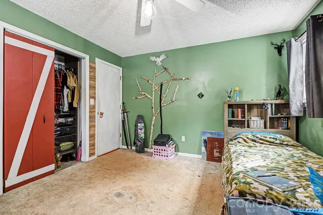 a bedroom with a bed and a walk in closet
