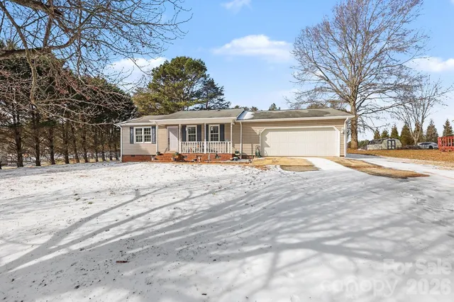 a front view of house with yard and trees around