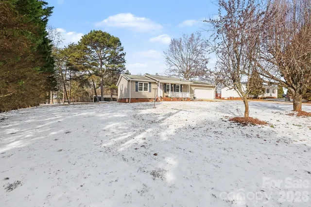 a front view of a house with a dirt yard