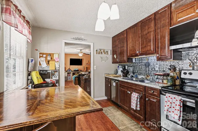 a kitchen with lots of counter top space appliances and cabinets