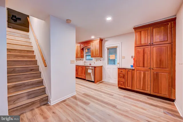 a view of a kitchen with wooden floor and stairs