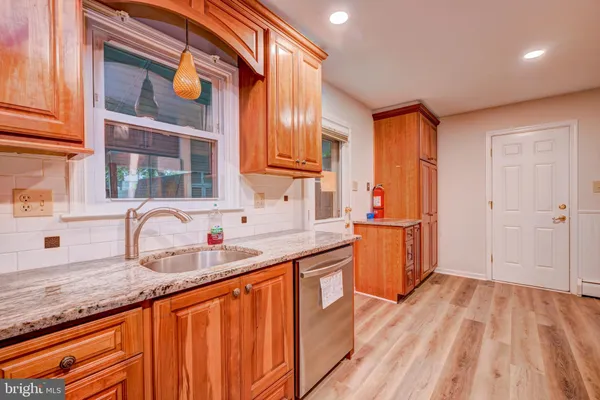 a kitchen with granite countertop a sink and cabinets