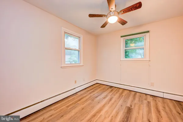 wooden floor in an empty room with a window