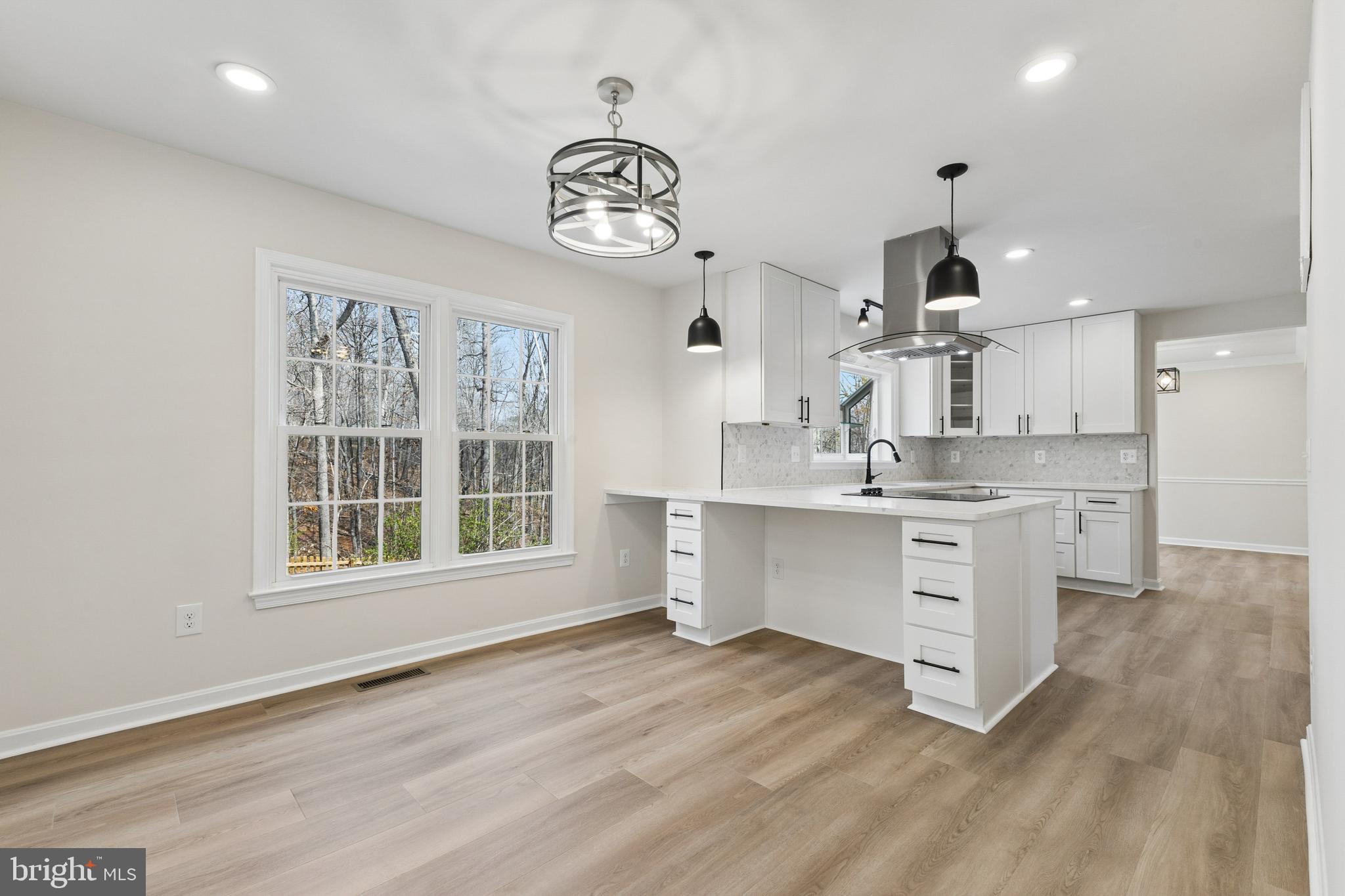 8 Lawhorn Road Stafford, VA 22554 - Photo 14 of 40 a large kitchen with kitchen island white cabinets and stainless steel appliances