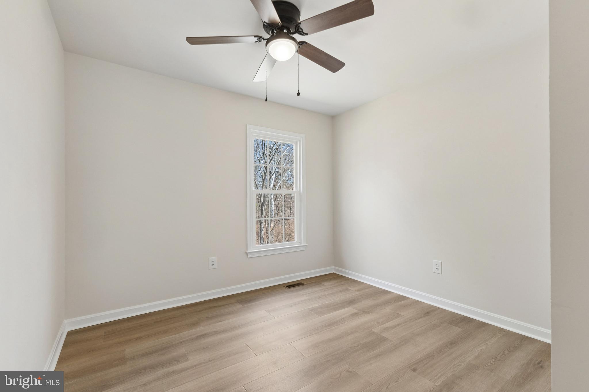 8 Lawhorn Road Stafford, VA 22554 - Photo 28 of 40 an empty room with wooden floor fan and windows