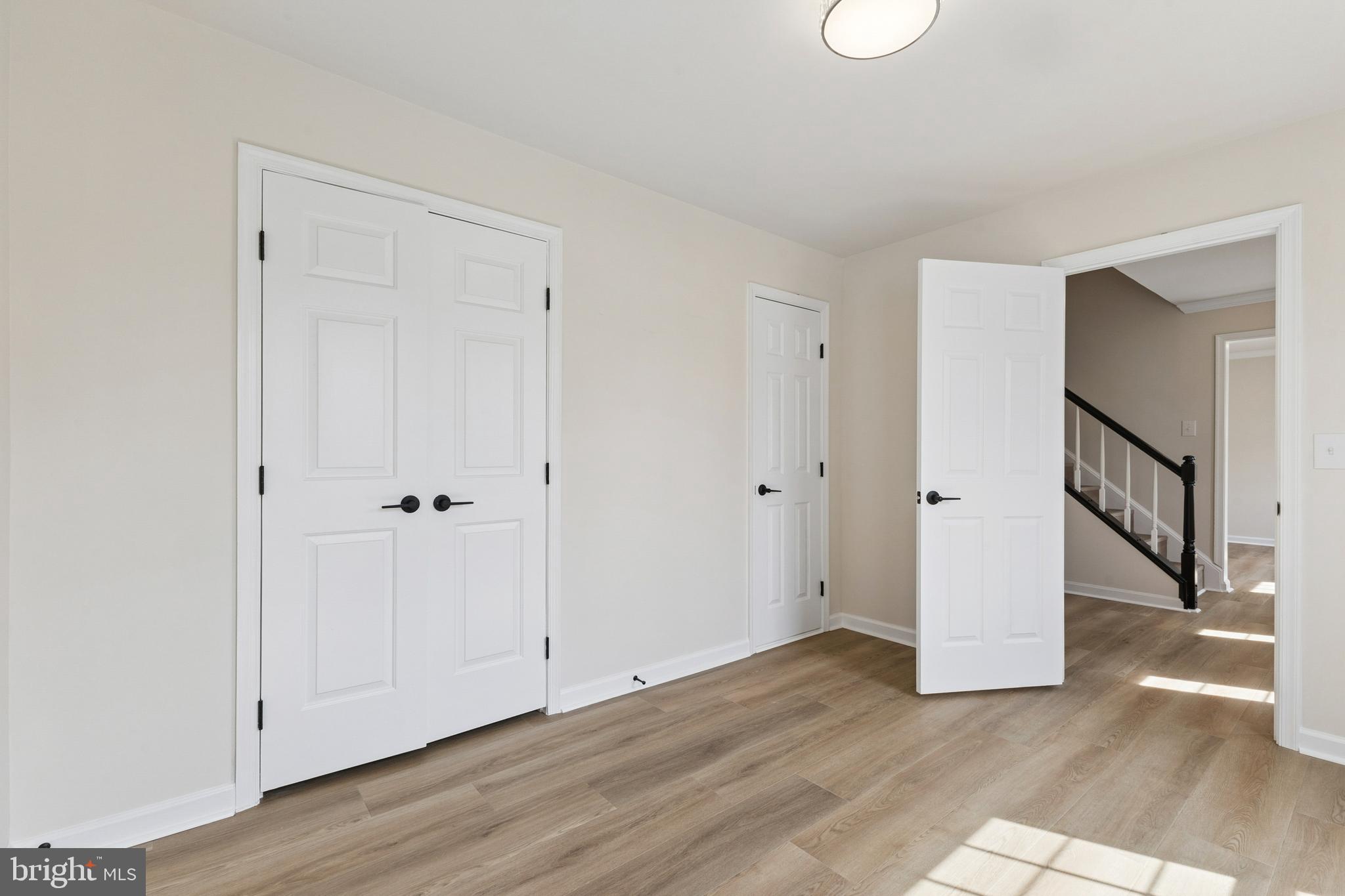 8 Lawhorn Road Stafford, VA 22554 - Photo 5 of 40 a view of an empty room with wooden floor and a hallway