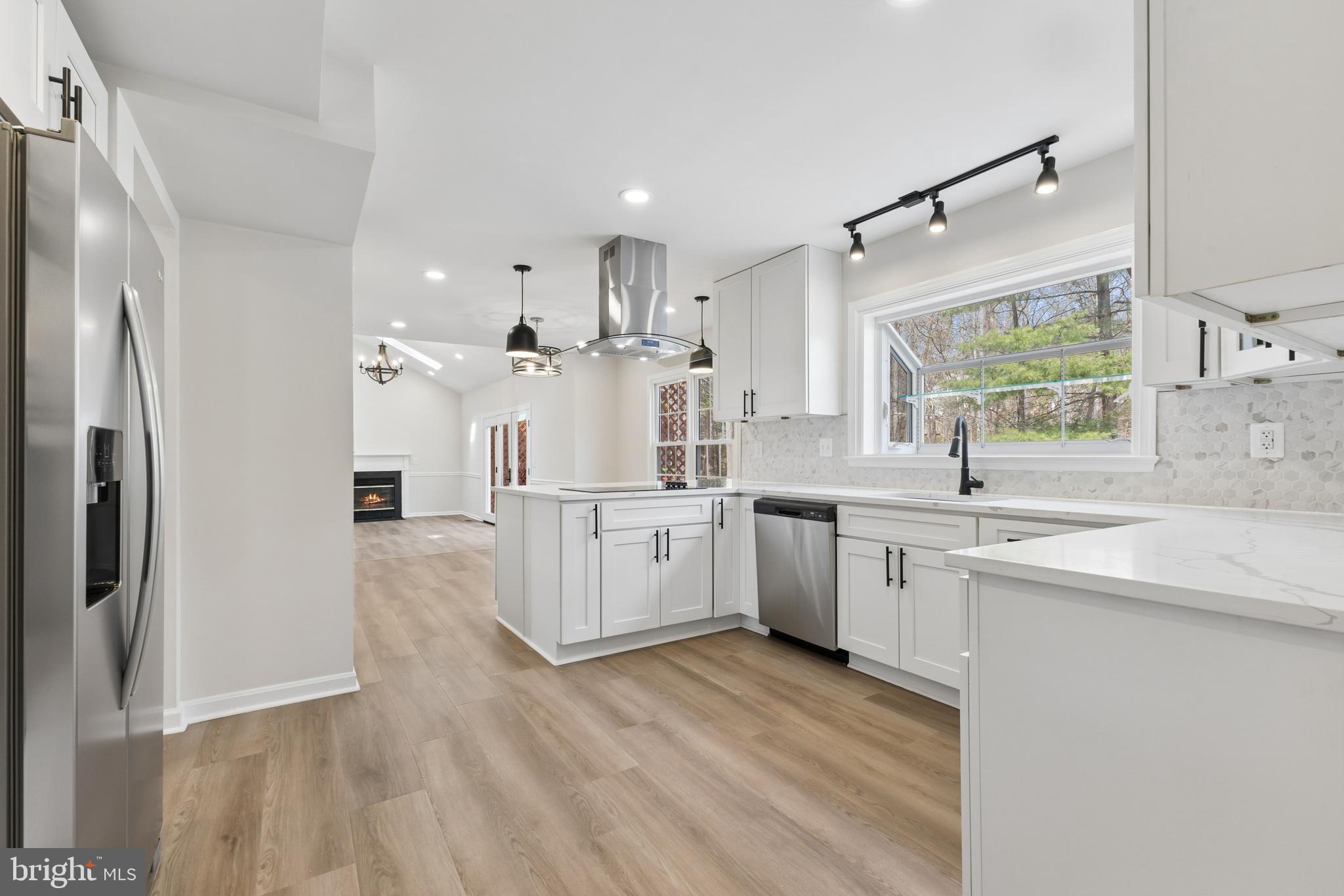 8 Lawhorn Road Stafford, VA 22554 - Photo 10 of 40 a large kitchen with kitchen island white cabinets and stainless steel appliances