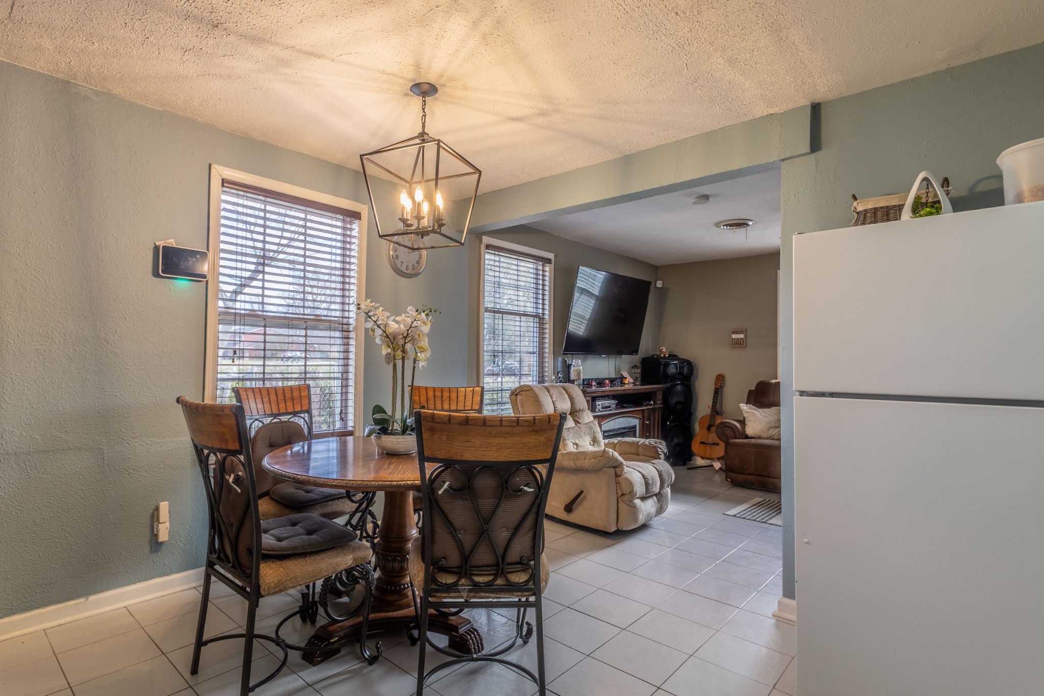307 Burch Road Clarksville, TN 37042 - Photo 8 of 17 a view of a dining room with furniture a chandelier and a refrigerator