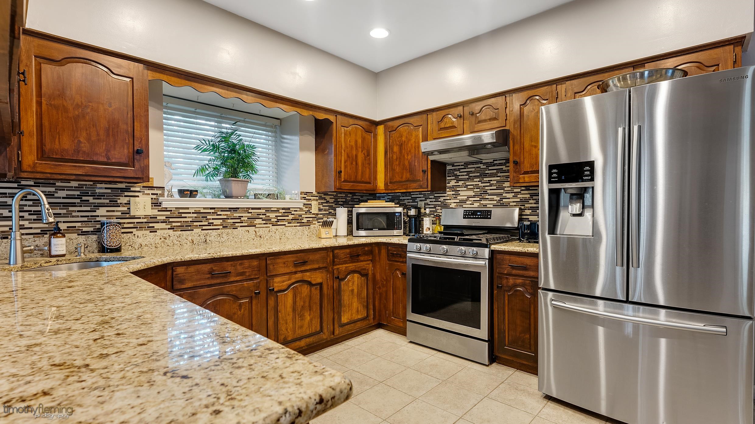 3 Inlet Ocean View, NJ 08230 - Photo 12 of 42 a kitchen with stainless steel appliances granite countertop a refrigerator sink and stove