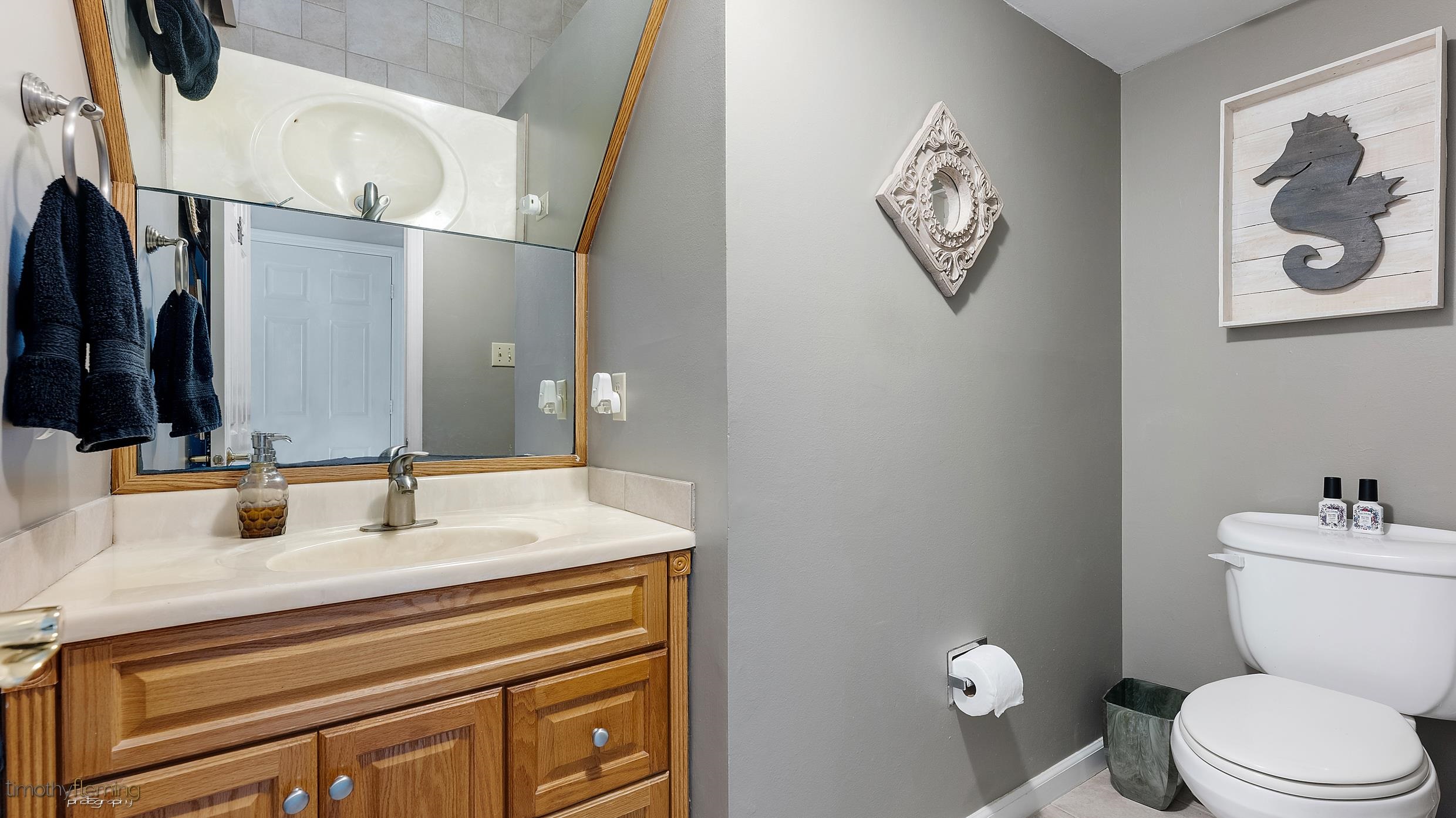 3 Inlet Ocean View, NJ 08230 - Photo 18 of 42 a bathroom with a toilet a sink and mirror