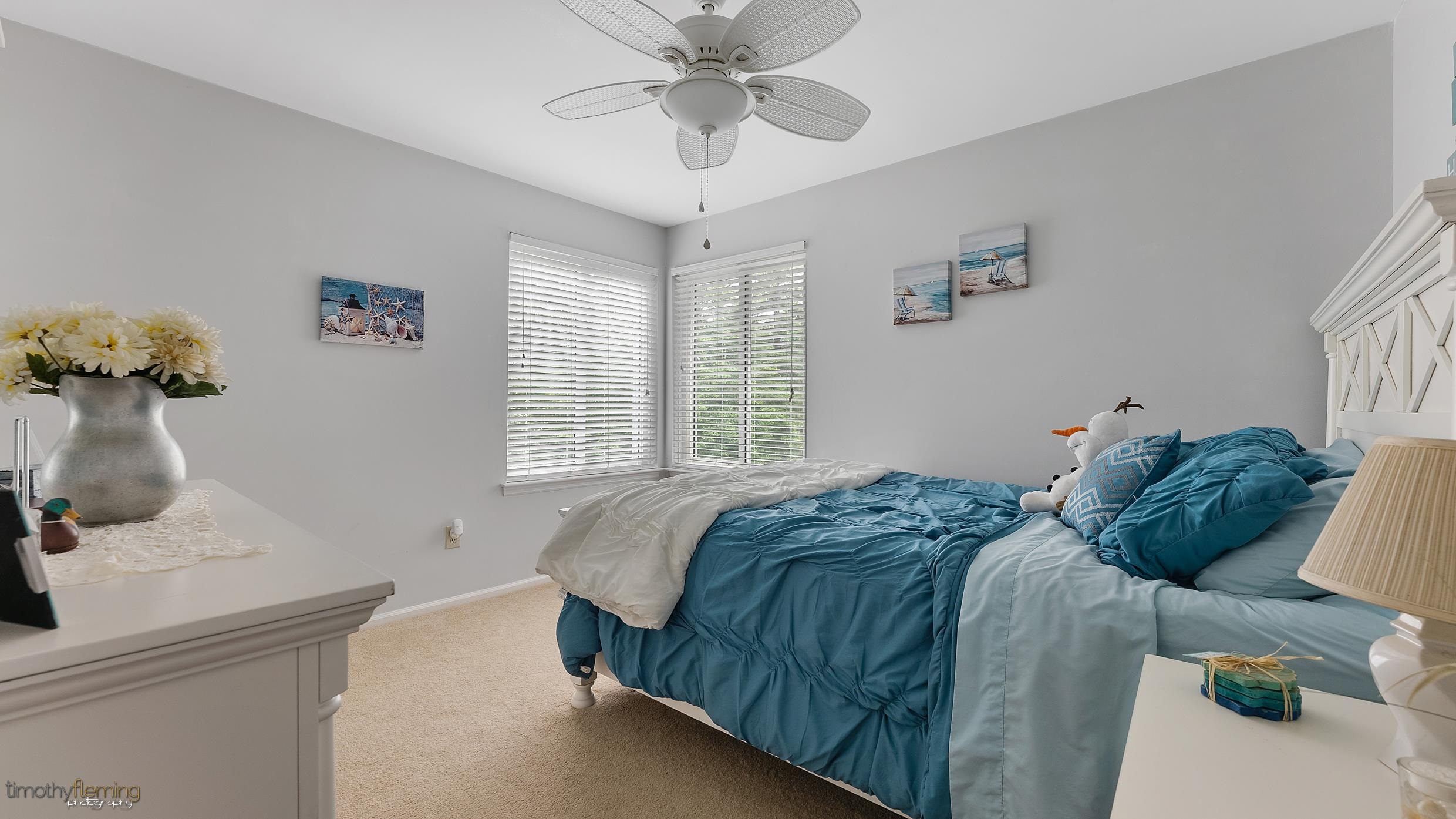 3 Inlet Ocean View, NJ 08230 - Photo 20 of 42 a bedroom with a bed and a chandelier