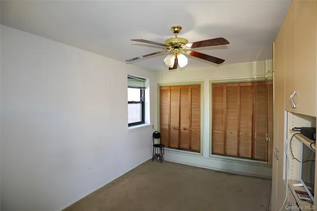 a view of a livingroom with a ceiling fan and a window