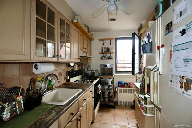 a kitchen filled with stainless steel appliances granite countertop a stove and a refrigerator