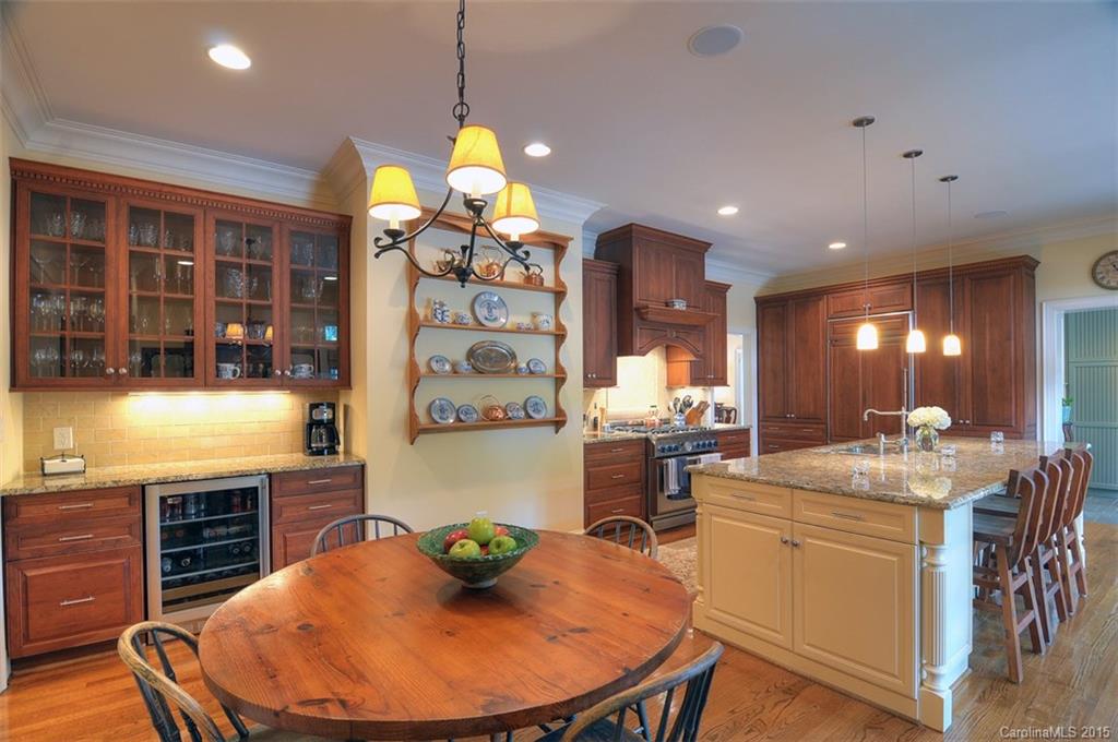 1518 Andover Road Charlotte, NC 28211 - Photo 11 of 22 a room with stainless steel appliances kitchen island granite countertop a table chairs in it and wooden floor