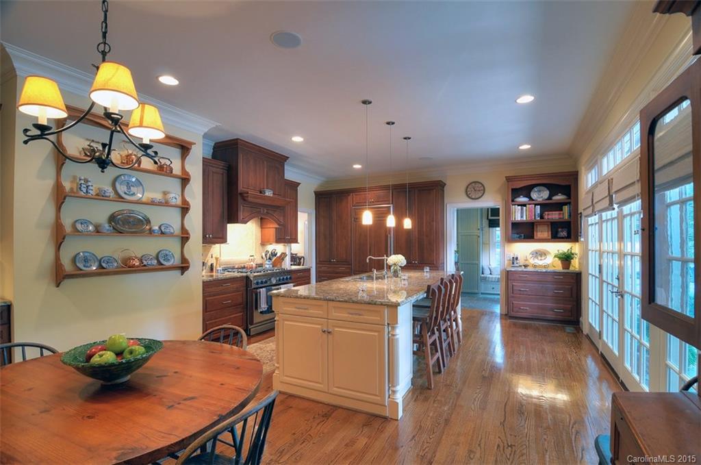 1518 Andover Road Charlotte, NC 28211 - Photo 10 of 22 a room with stainless steel appliances kitchen island granite countertop furniture and a wooden floor