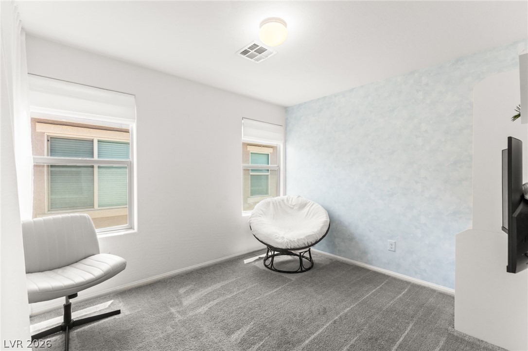 6435 Point Isabel Way Las Vegas, NV 89122 - Photo 34 of 57 A well-lit secondary room, ideal for a flexible living space, features two windows and soft carpeting.