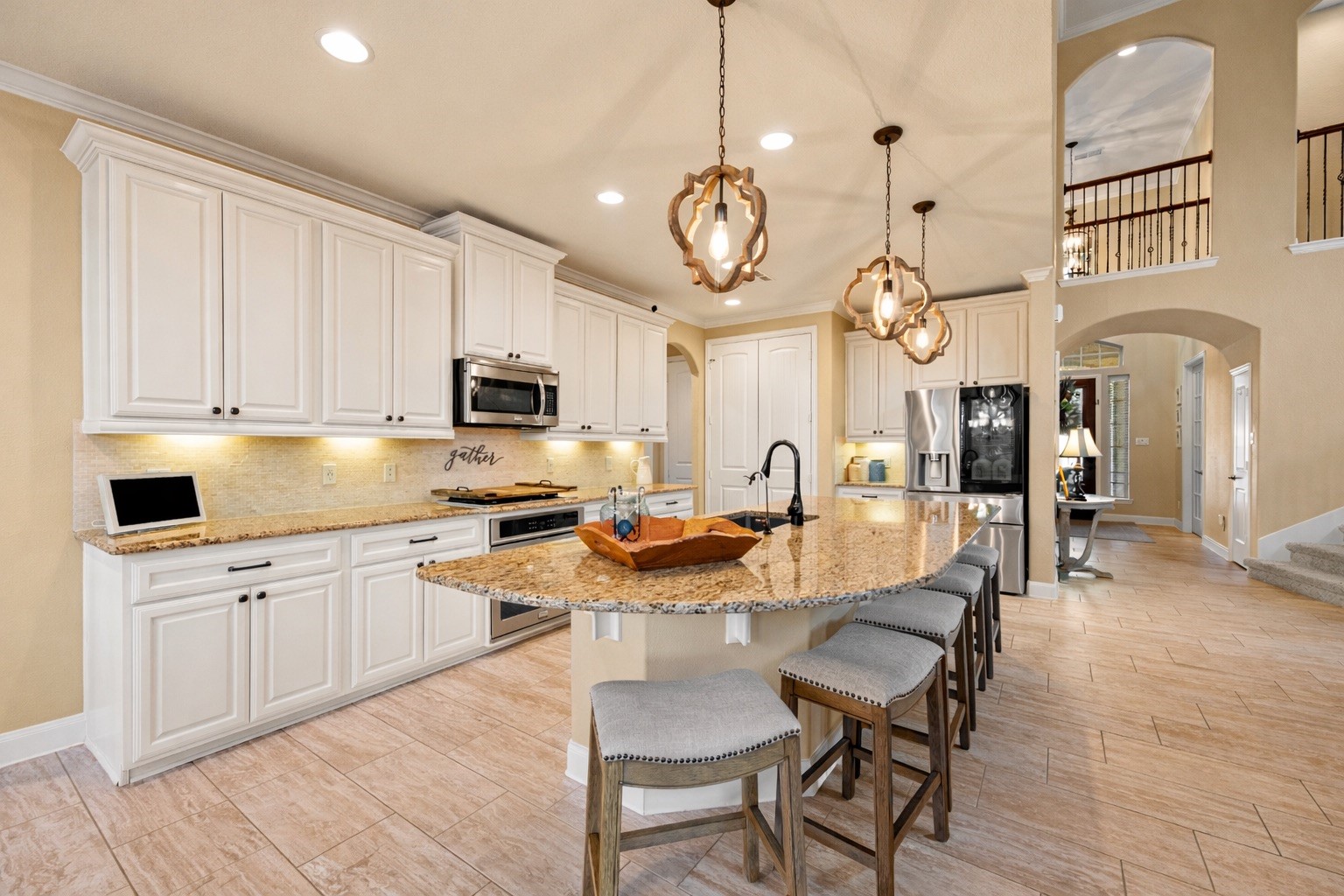 9518 Three Stone Lane Tomball, TX 77375 - Photo 16 of 33 Beautiful kitchen with plenty of cabinetry and counter space that flows nicely into the hallway with the laundry room and passes through to the master bedroom.