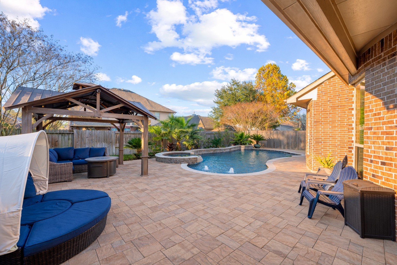 9518 Three Stone Lane Tomball, TX 77375 - Photo 31 of 33 The patio overlooks a well-maintained backyard with lush greenery and a privacy fence.