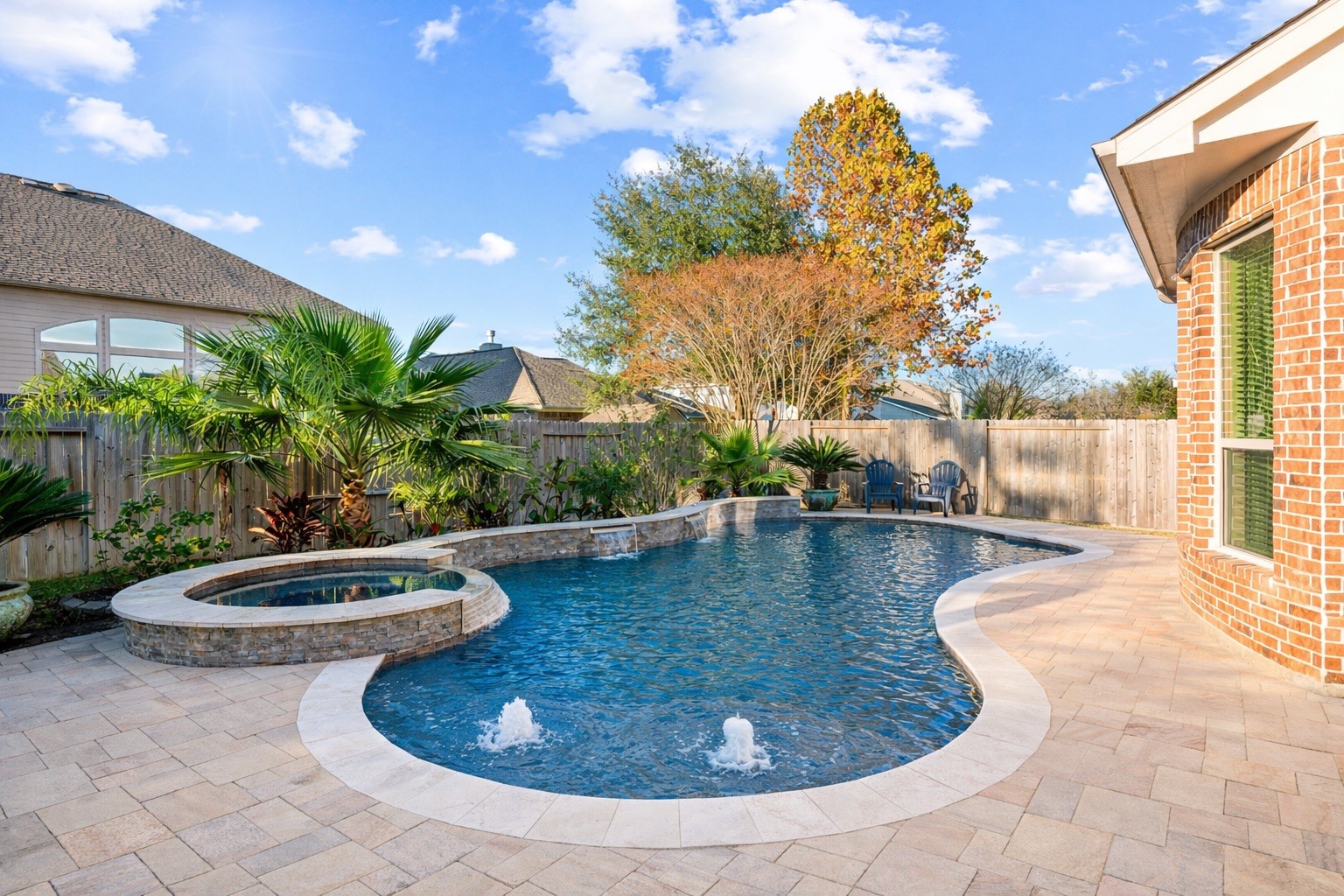 9518 Three Stone Lane Tomball, TX 77375 - Photo 7 of 33 Well-maintained backyard oasis with a swimming pool and hot tub.