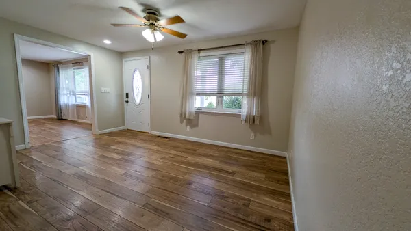 wooden floor in an empty room with a window