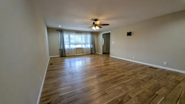 wooden floor in an empty room with a window