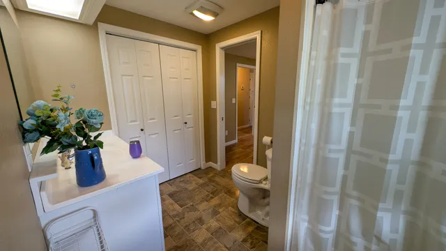 a bathroom with a sink a toilet and shower