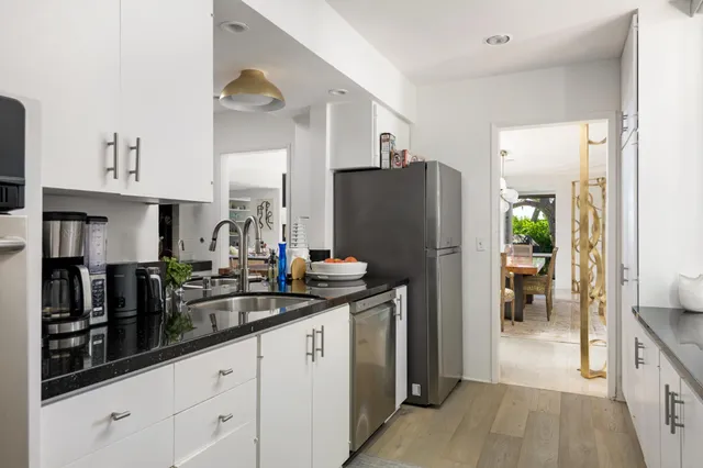 a kitchen with refrigerator and cabinets