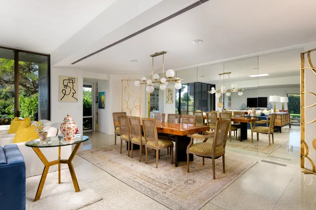 a view of a dining room with furniture and chandelier