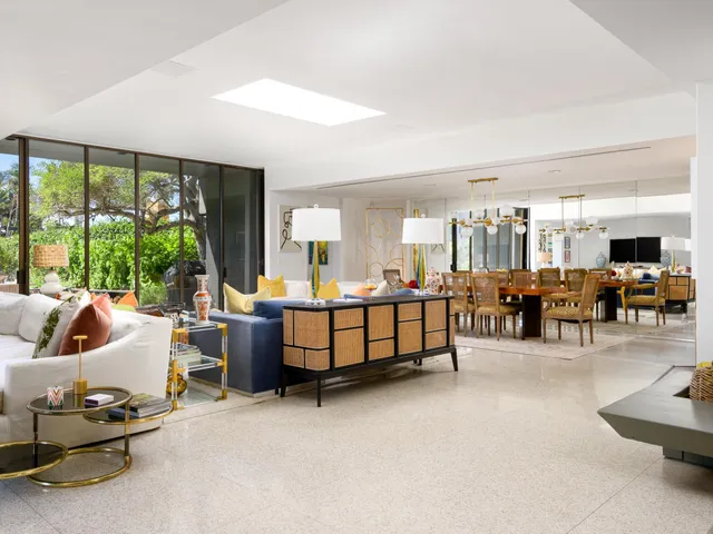 a bedroom with furniture and a large window