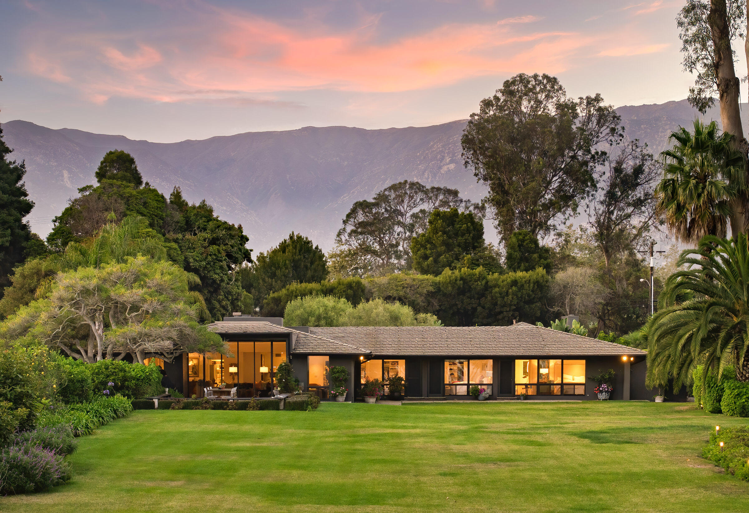 1695 Fernald Point Lane Montecito, CA 93108 - Photo 2 of 38 a view of a white house with a big yard and large trees