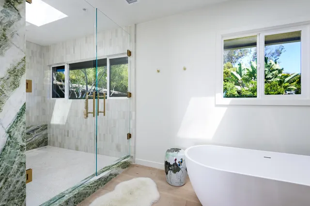 a bathroom with a tub and a shower