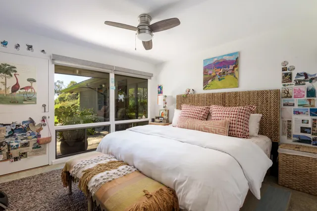 a bedroom with a large bed and a large window