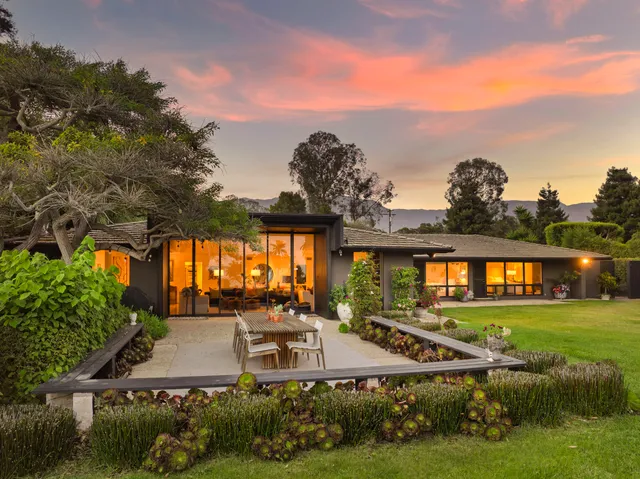 a view of a house with swimming pool and yard