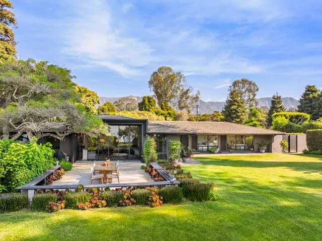 a front view of a house with a big yard
